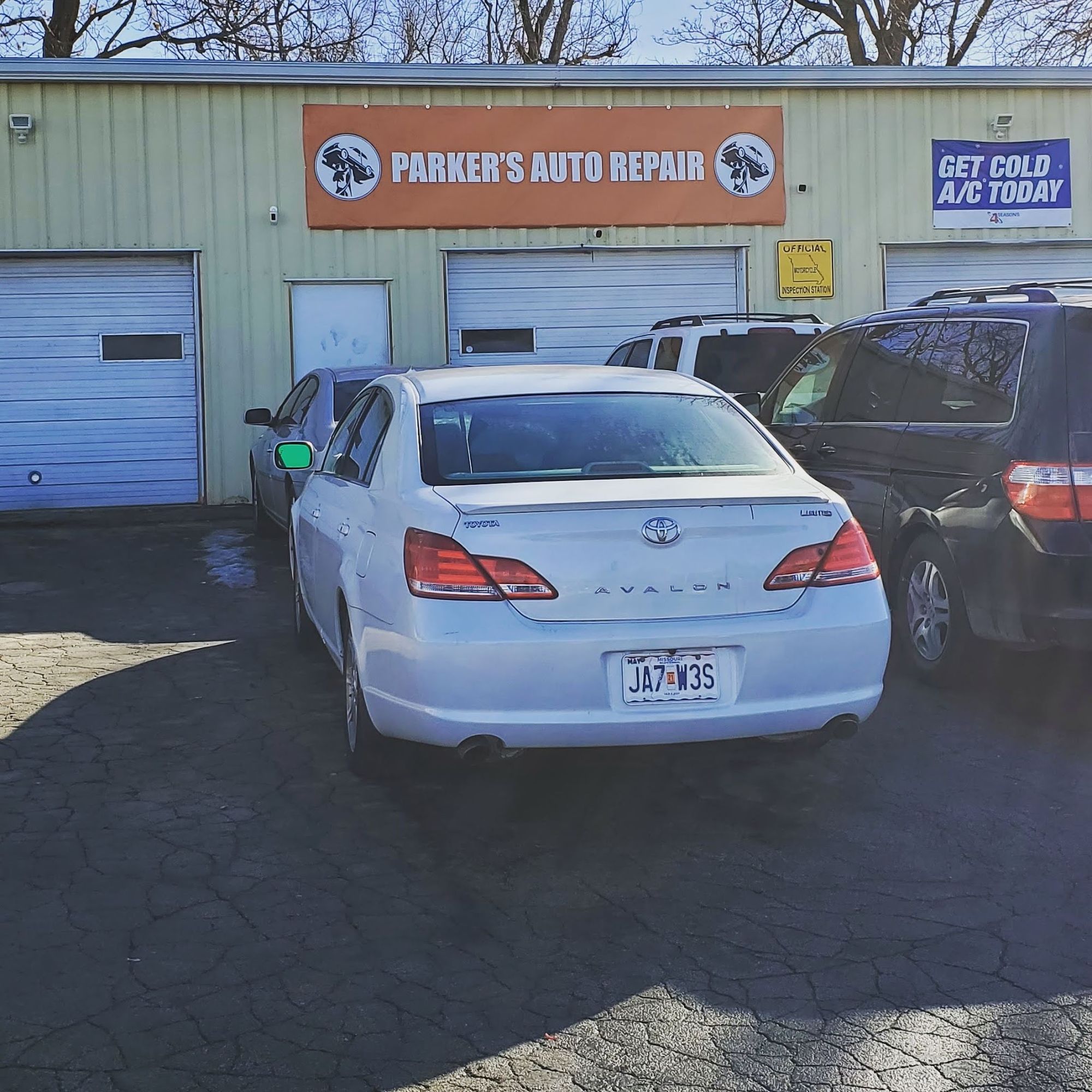 The front of Parker's Auto Repair on the South Belt, garage bays under the orange banner